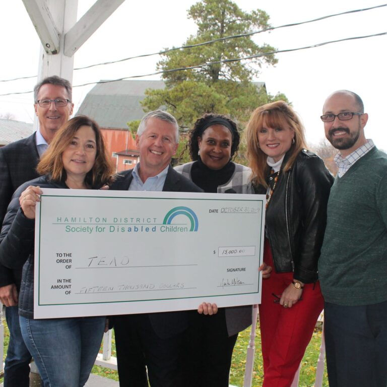 Group of people holding large check made out to TEAD