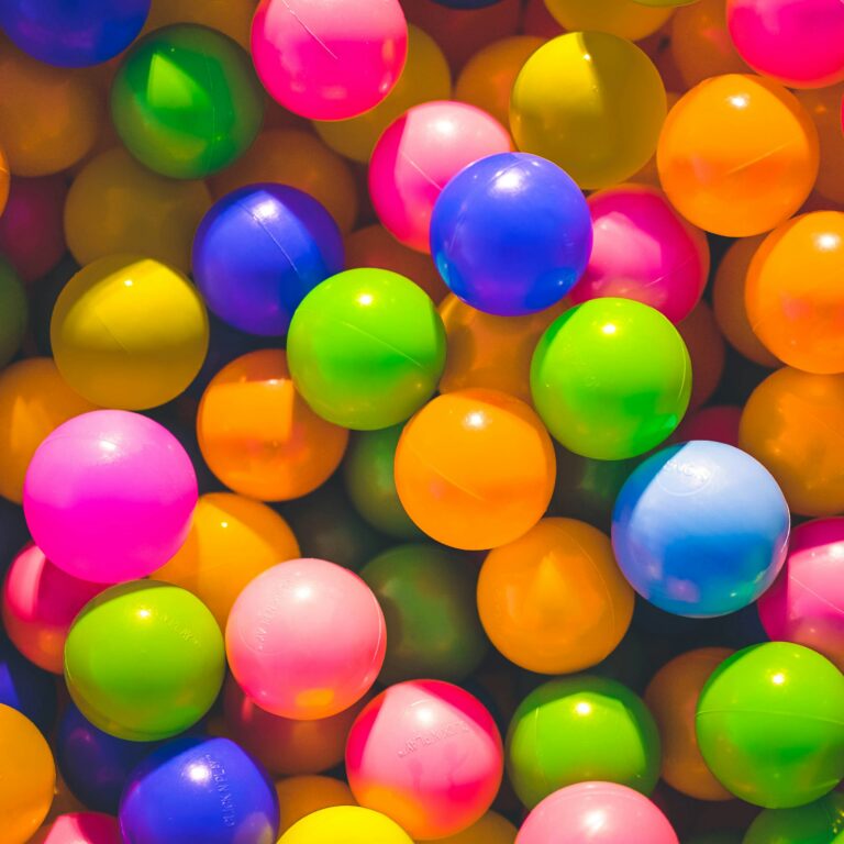 many balls of different colors in a bin